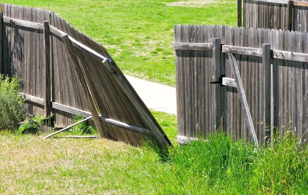 Old wood fence being torn out and removed from a Wichita property