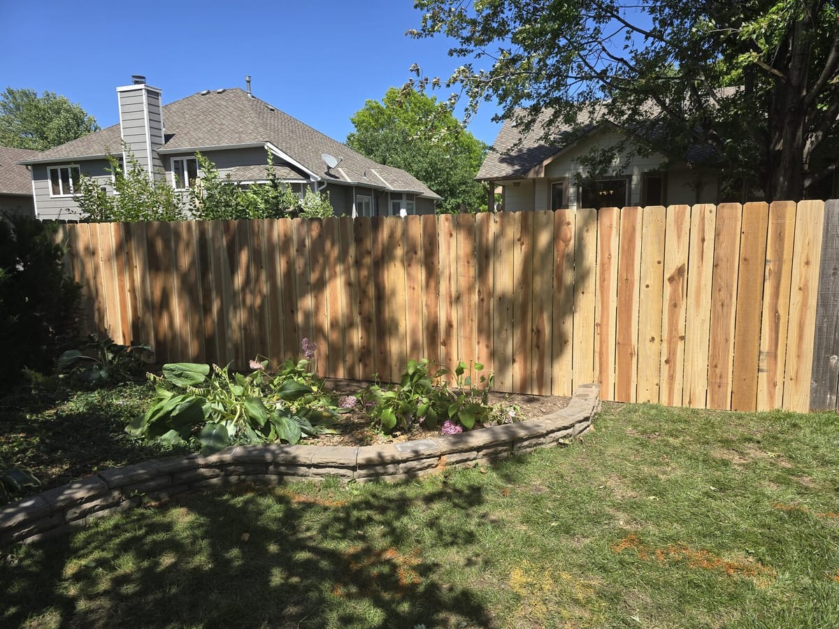 Close angle of the new cedar privacy fence after storm rebuild