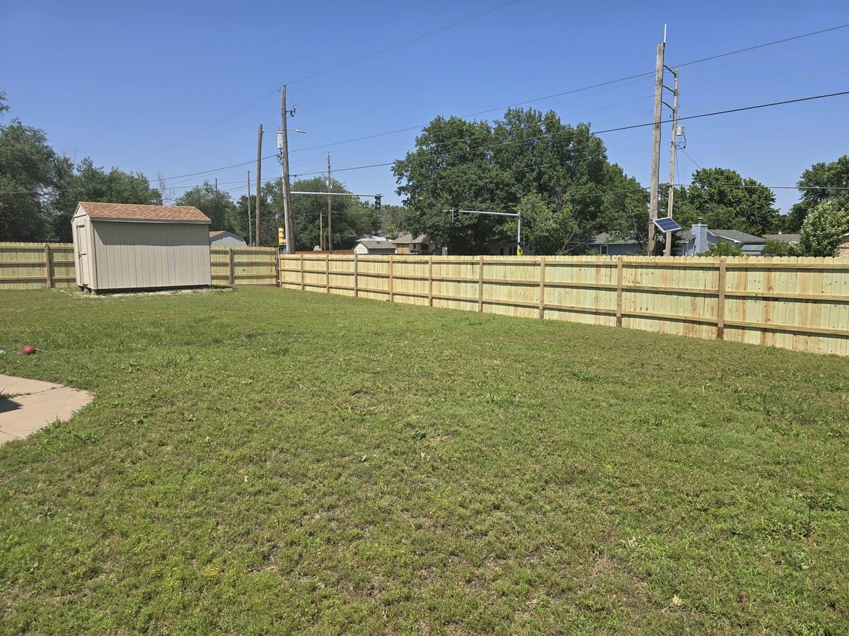Cedar privacy fence running the length of the yard, second angle